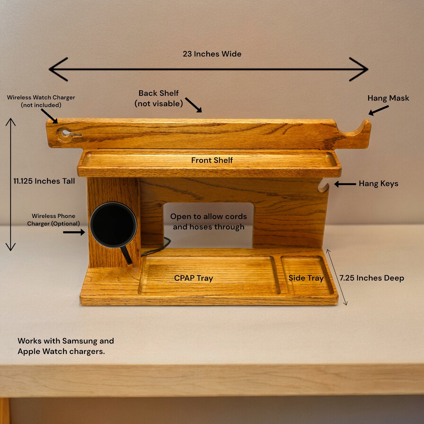 The image displays the CPAP Smart stand with optional wireless phone charger. The image includes the stands dimensions for 23 inches wide by 11.125 inches tall by 7.25 inches deep. It displays the different catch-all trays along with placement for the CPAP machine. The descriptions also shows that it works with Samsung and Apple watches and phones.