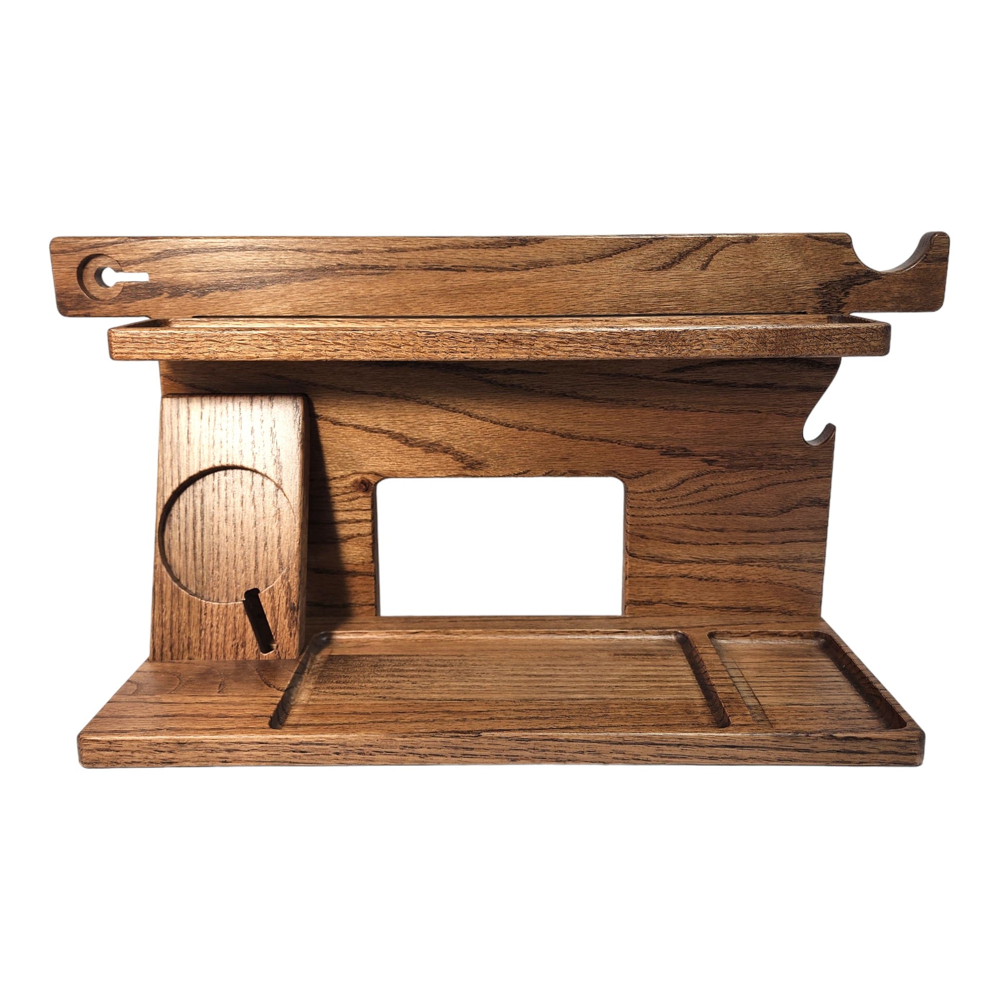 An empty CPAP Smart Stand made by Custom Cave Works.  This smart stand does not include the optional wireless phone charger.  The stand is on a white background and includes places to put your smartphone, smartwatch, change, keys and wallet.  The stand is sold oak wood that has a satin finish.