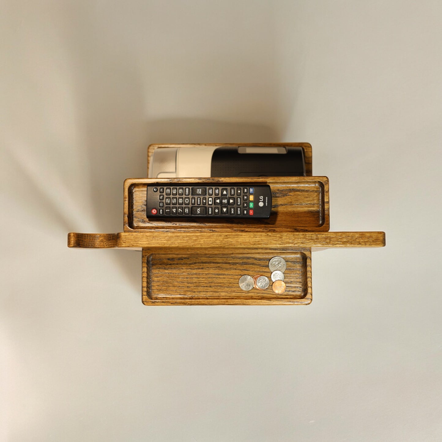 A top view of the CPAP Smart Stand made by Custom Cave Works. The stand is made from solid Oak wood and shows a very organized view of the catch-all trans, including the one on the back side of the stand.