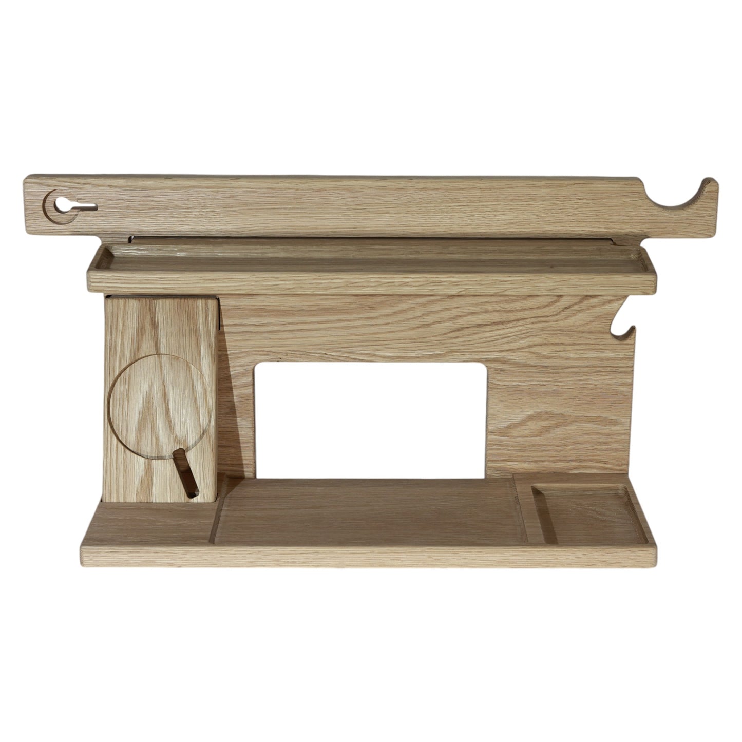 An empty CPAP Smart Stand made by Custom Cave Works. The stand is on a white background and includes places to put your smartphone, smartwatch, change, keys and wallet. The stand is sold oak wood that has a satin finish.
